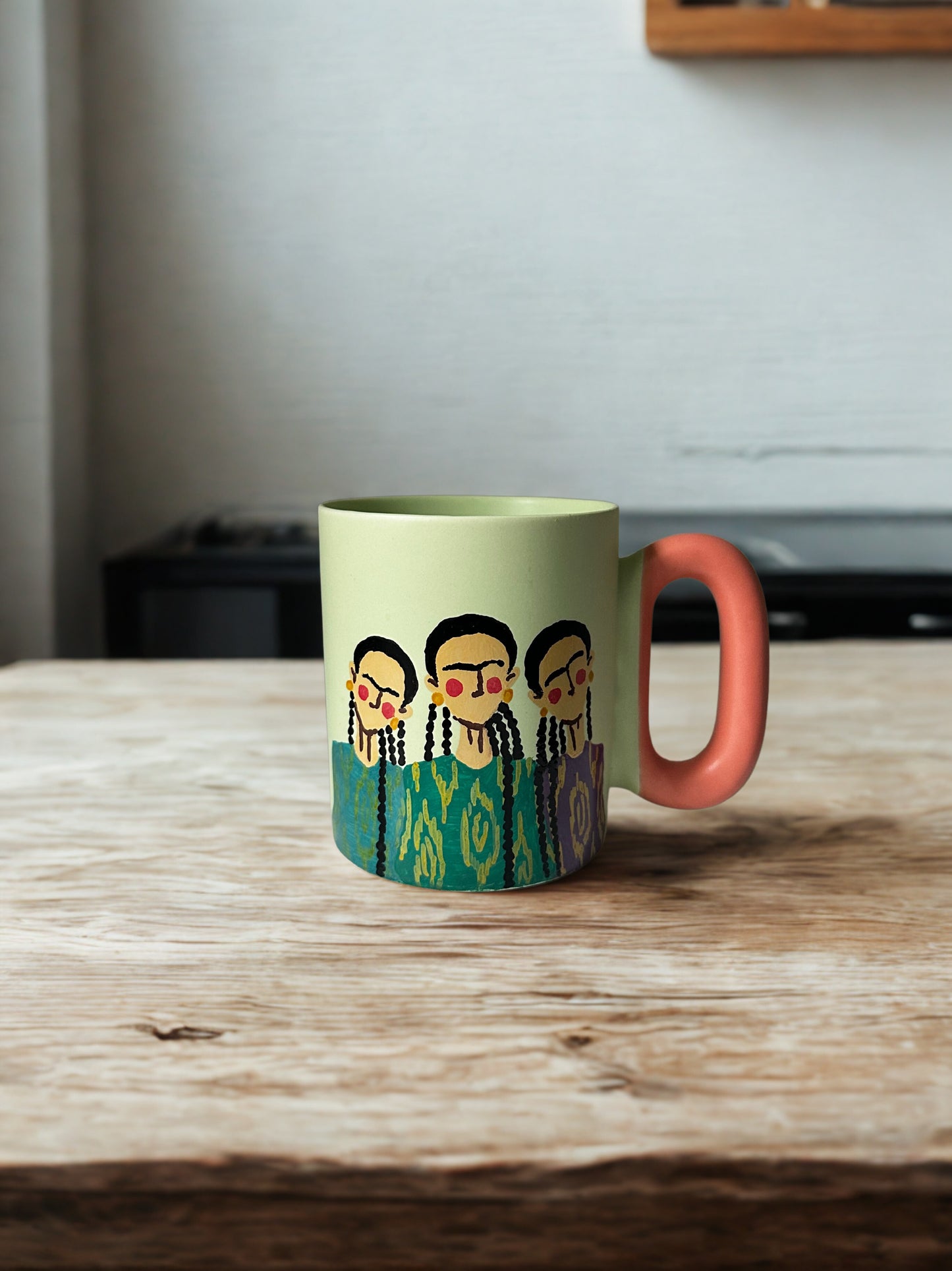 3 Uyghur girls on pastel green mug