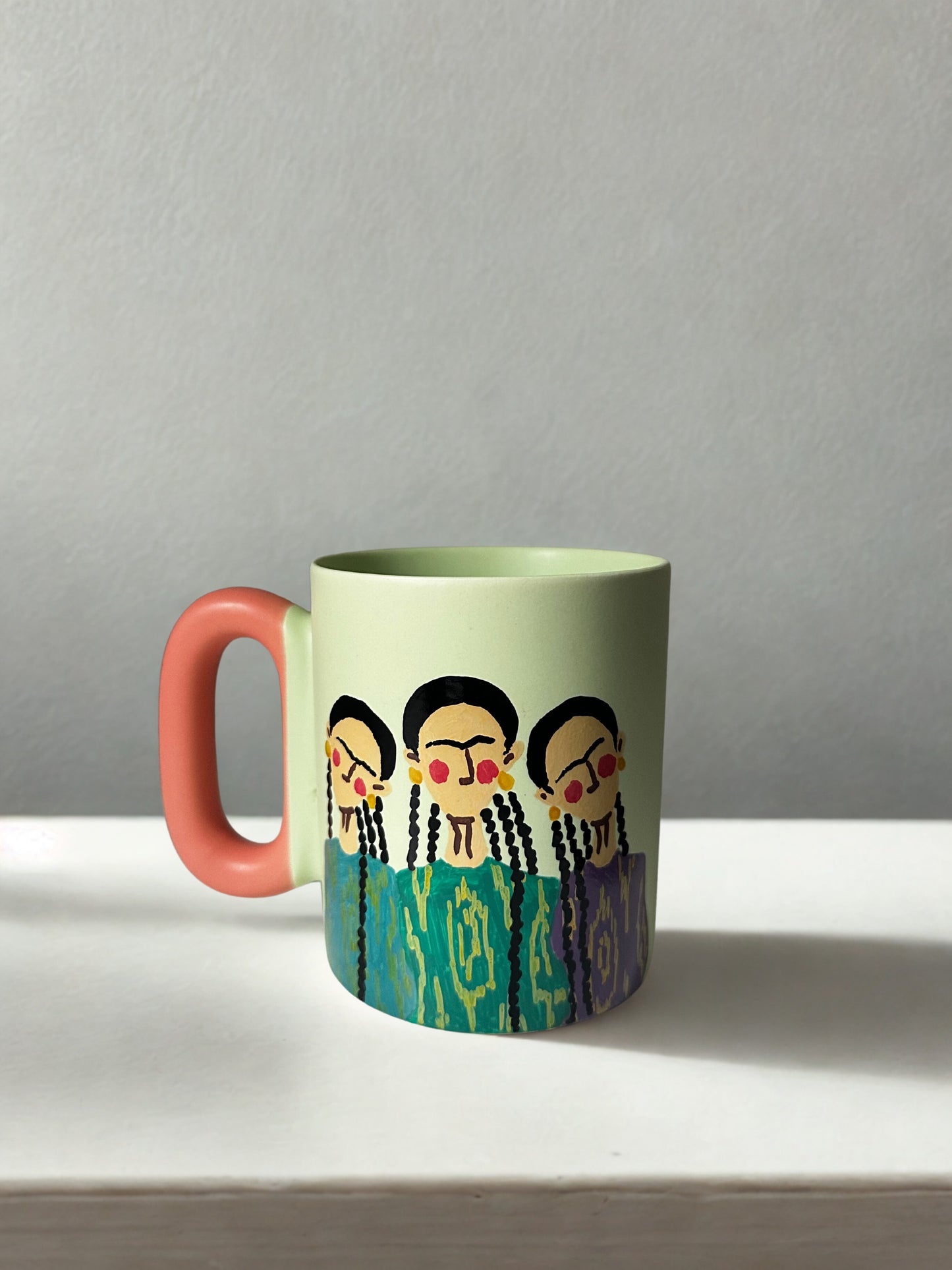 3 Uyghur girls on pastel green mug