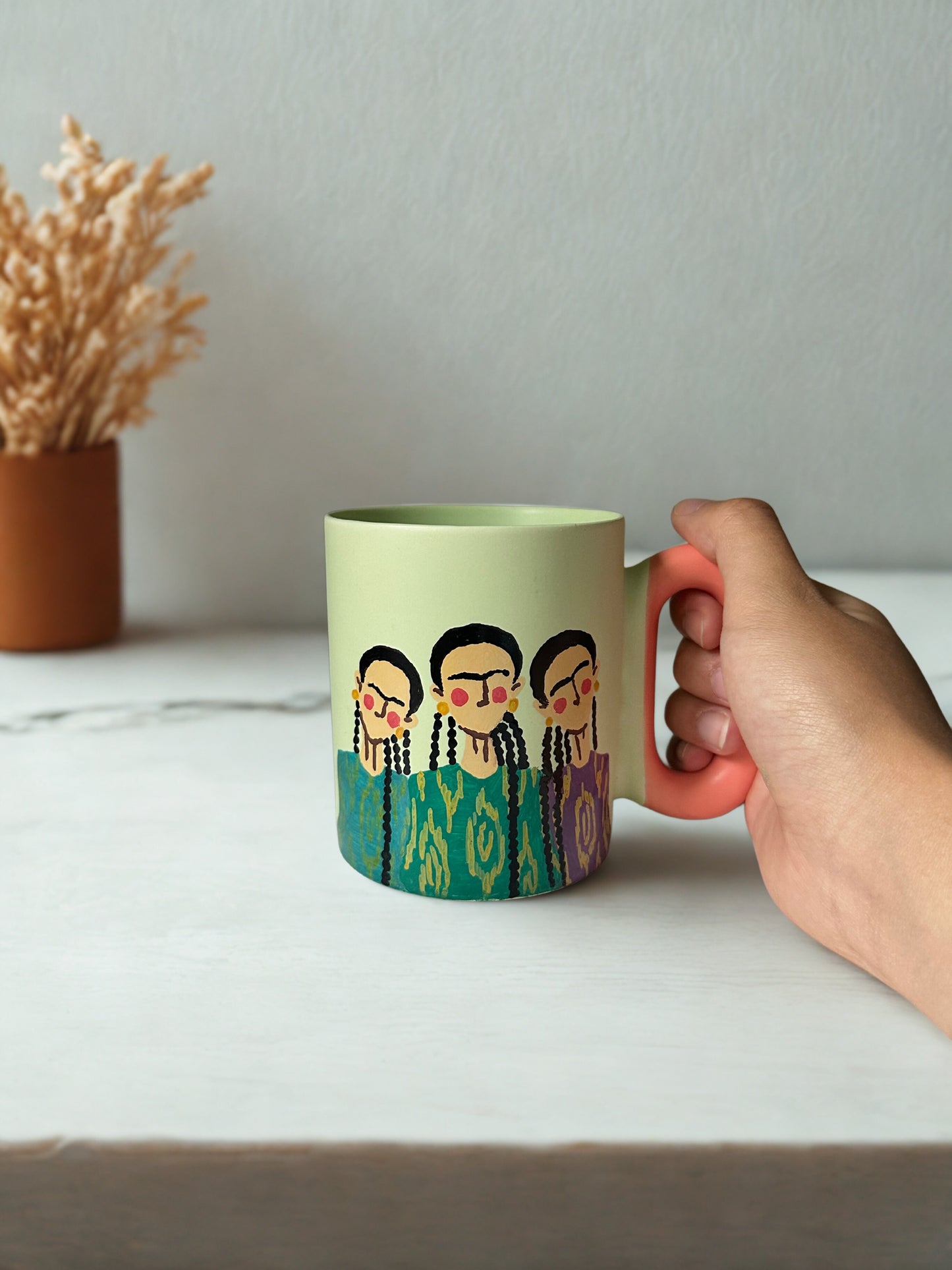 3 Uyghur girls on pastel green mug