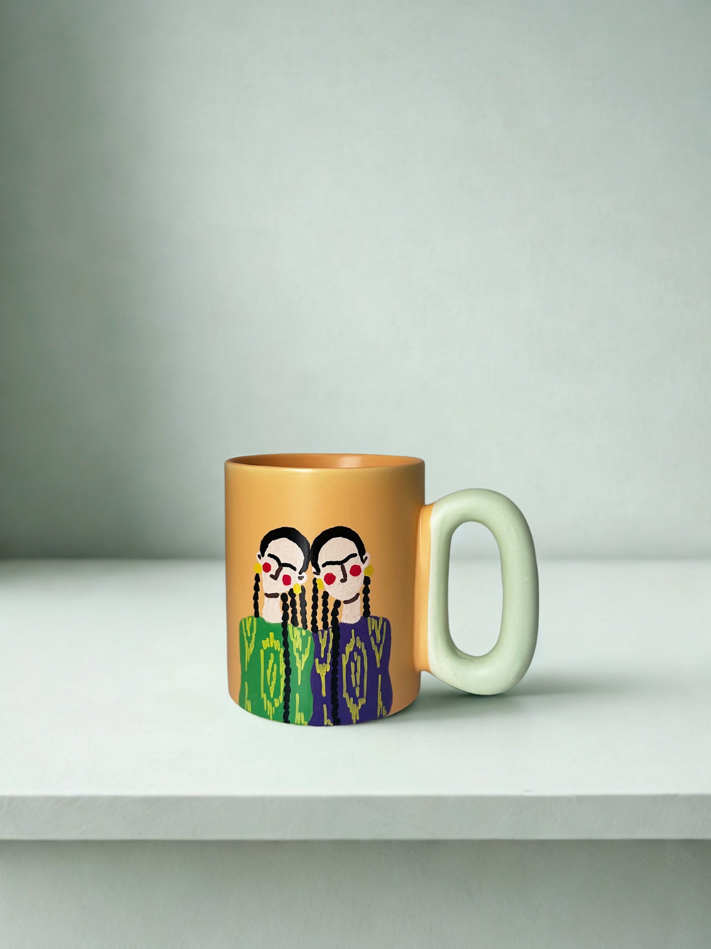 2 Uyghur girls on pastel orange mug